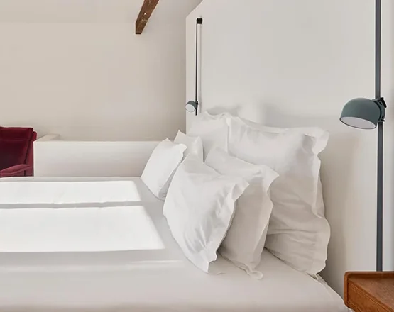 Room Studio at Casa Fortunato with twin beds, wooden beam ceiling, and balcony access