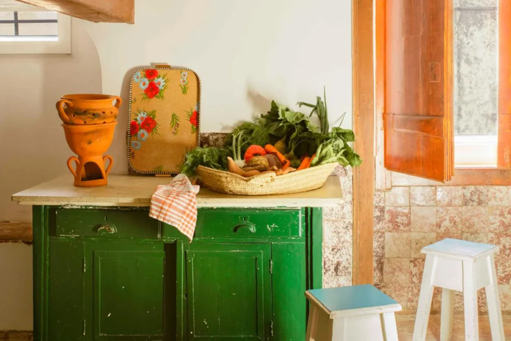 Rustic Alentejo kitchen counter with a woven basket of fresh organic vegetables, prepared for a private chef's sharing plates