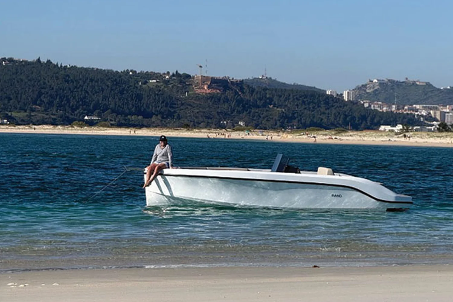 Guest enjoying a private boat tour on the water near Casa Fortunato, with the Alentejo coastline in the background