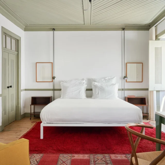Private Hiring of Casa Fortunato and enjoy it exclusively.
Book Now! 
www.casafortunato.com
Creating a subtle canvas of salvaged white walls edged with leaded green accents, entering #1 feels fresh and breezy. Simplicity meets eclecticism – a scrubbed pine floor and crisp double bed awaits, laye- red on top with the spoils of the owners’ collection– a Foscarini Filo table lamp, Marc Newson Nimrod chair and Moroccan rugs in scarlet reds are the designer touchpoints which make up the splashes of colour in this clever melange. A handmade glazed-tiled walk-in rain shower in bottle greens reflect across the bathroom and it come complete with a vintage vanity table. In front of the window there is a sizable writing desk for those creative moments.
Looking forward to welcome you !